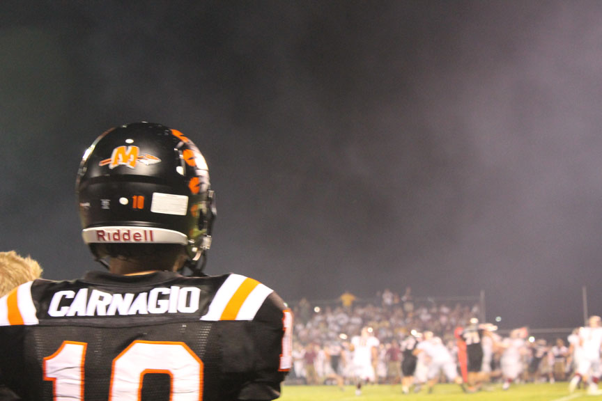 Quarterback John Carnagio watches the defense from the sidelines in the game against Morris on Aug. 29.