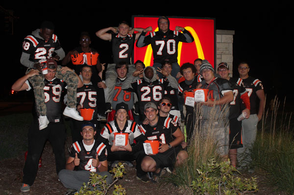 Members of the varsity football team pose in front of the McDonalds sign where they held a fundraiser on Oct. 6.  Twenty percent of the sales went to the Shawn Capodice Memorial Fund.