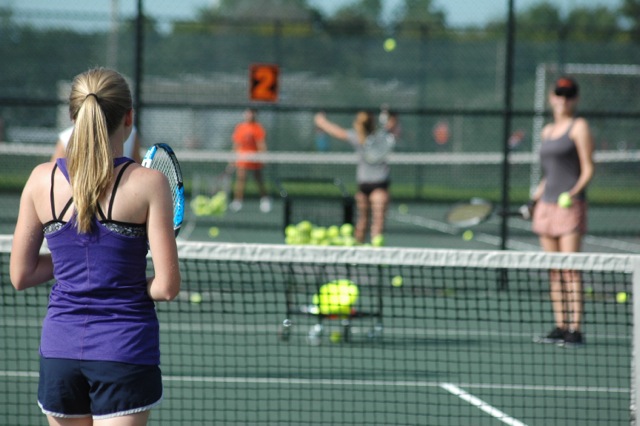Morgan Gierman, senior, stands ready to return a serve by head coach Jinger Shorette at practice on Aug. 31.
