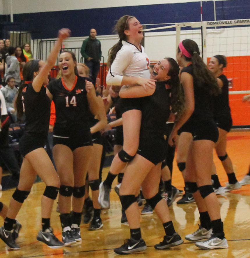The+girl+volleyball+team+celebrates+their+win+over+Plainfield+Central+on+Nov.+3.+Minooka+won+the+sectional+title.+