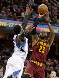Small forward Lebron James takes a shot over Shabazz Muhammad. James has expressed that the team needs a “playmaker.”
