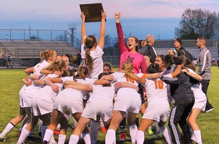 Hailey+Arlis+holds+up+the+Southwest+Prairie+League+Conference+Championship+plaque+while+the+MCHS+girls+soccer+team+celebrates+their+first+conference+championship+in+36+years+at+home+on+Senior+Night%2C+May+9%2C+2017.