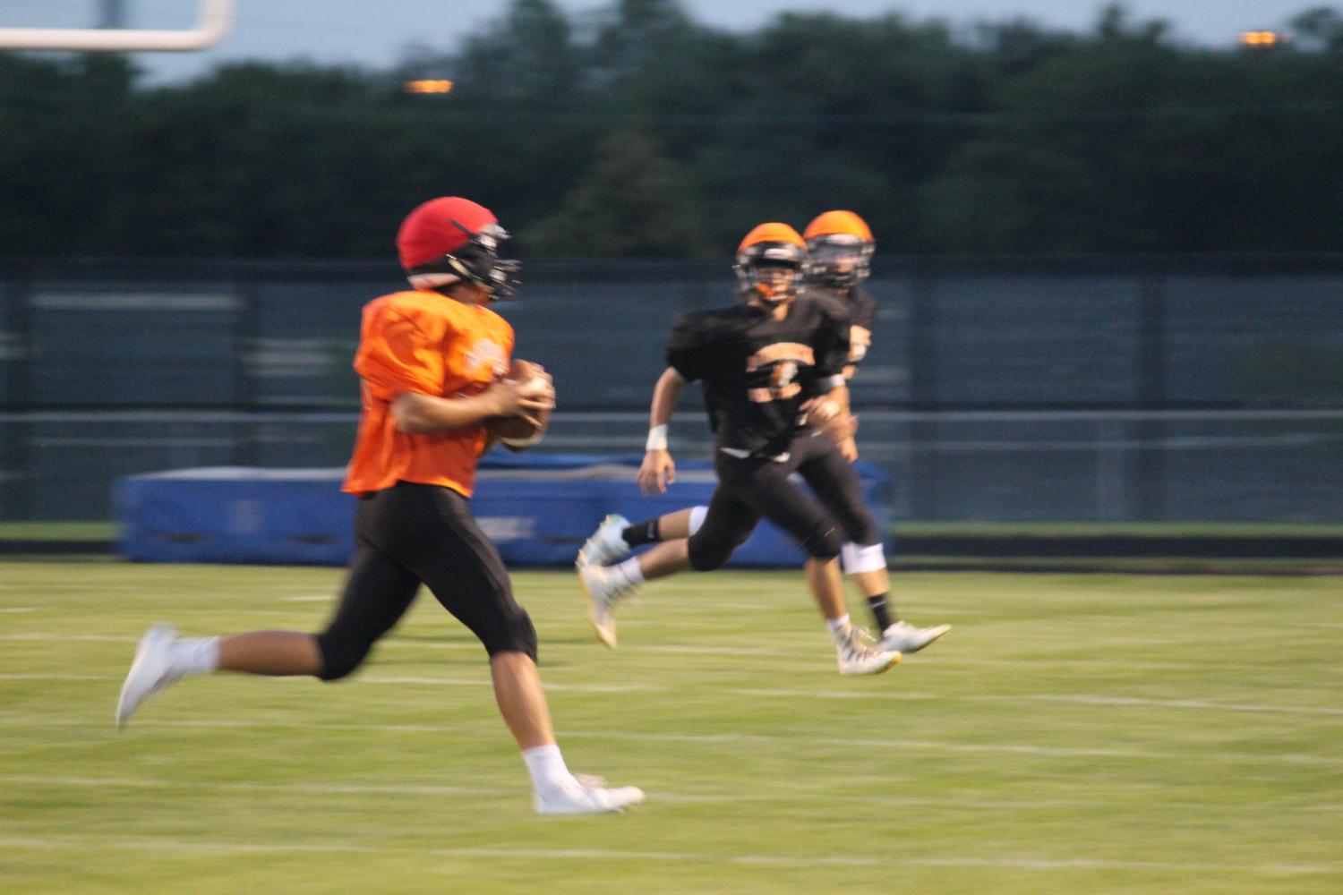 Senior+quarterback+Zach+Gessner+looks+to+pass+at+the+Meet+the+Indians+scrimmage+on+Aug.+18.+