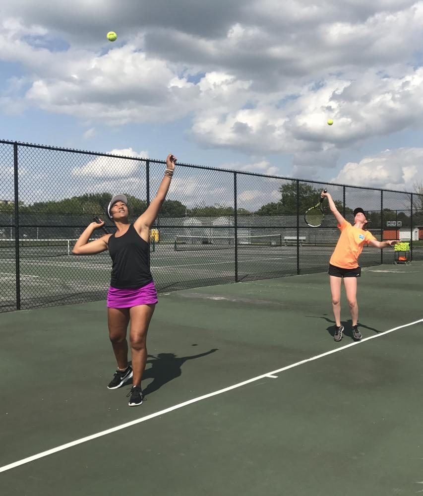 Seniors Emily Goggins and Grace Thelo practice serves on Aug. 24. 