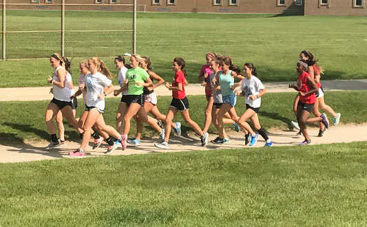 Members of the girls cross country team run at practice on Aug. 24. 