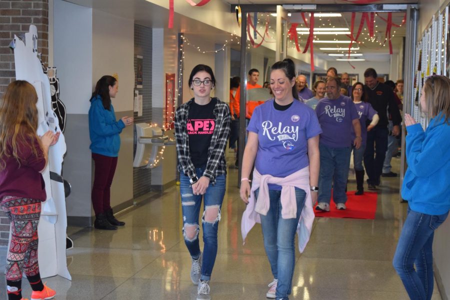 Senior Evie Swink walks during the survivor lap with her mom, who provided the prize of homemade cupcakes to those who participated in French Zumba during the FNHS lap.