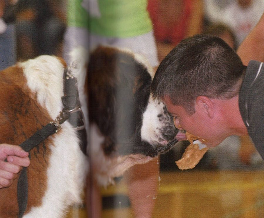 Mr. Mark Brown, social studies, kisses a dog at the 2008 Homecoming Assembly. The kiss was part of a fundraiser for breast cancer. 