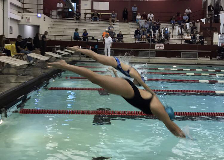 Minooka senior Steph Melendez starts the 50-meter fly at a meet in September against Dekalb. Melendez is one of several Minooka athletes who compete with the name Morris on their suits. 