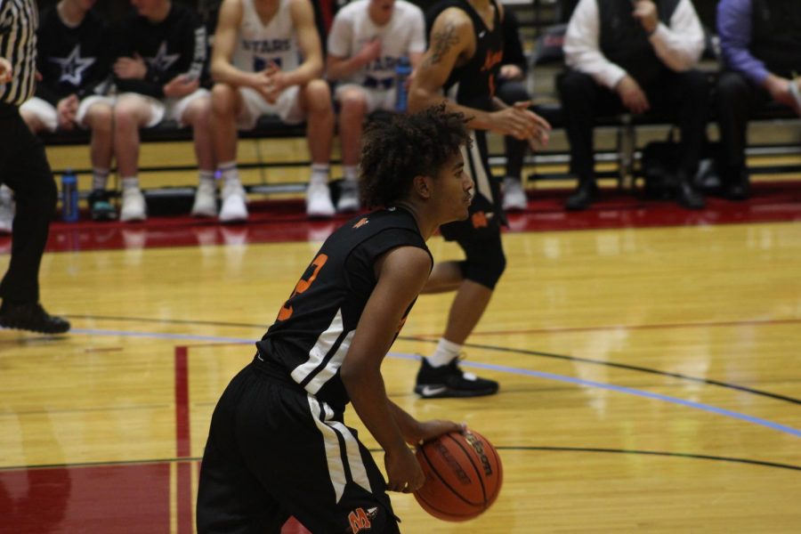 Senior Jaedon Johnson brings the ball up the court against St. Charles North. 