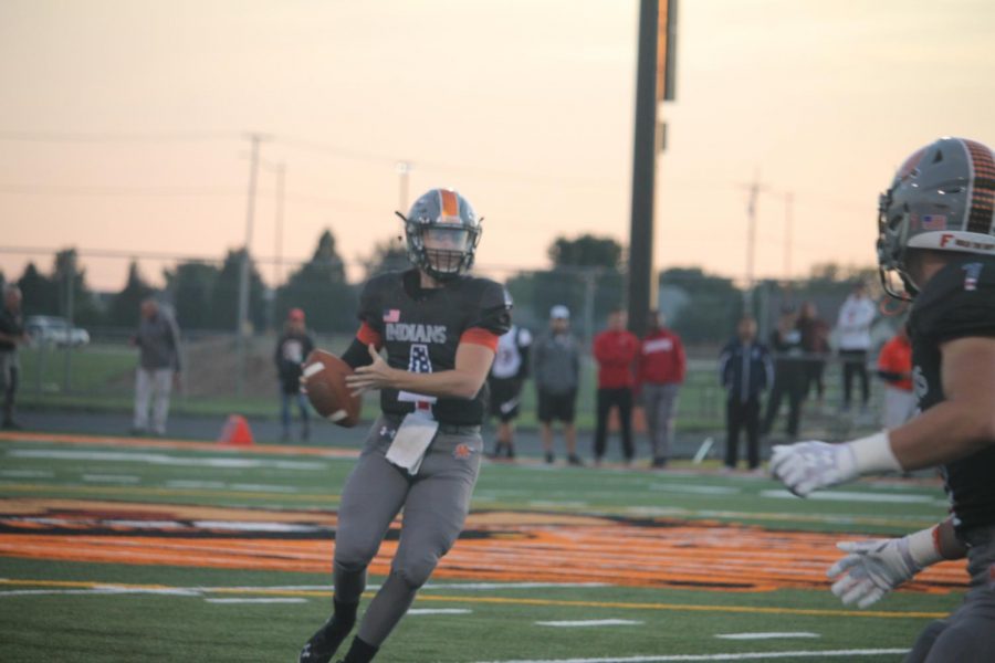 Senior quarterback Seth Lehr looks downfield early in the first quarter against Plainfield East. Lehr was injured on a late hit shortly thereafter and did not return in the game. 