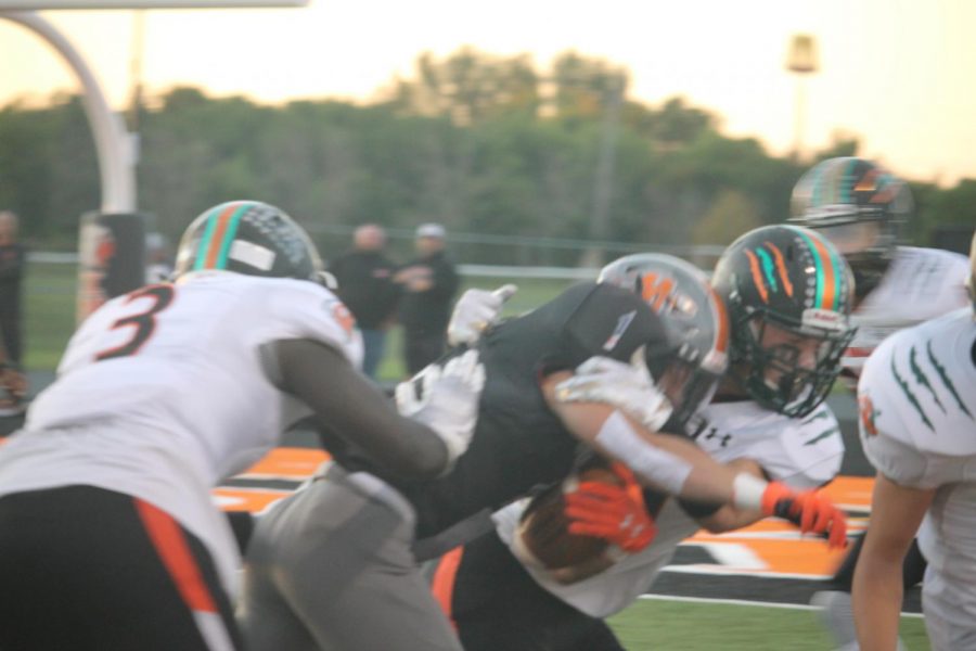Multiple defenders from Plainfield East try to bring down wide receiver Steven Gonzalez on Sept. 13. 