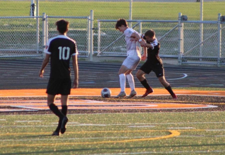Alex Rictor, senior, looks for the ball and fights with a Providence defensive player in order to reach the ball. 