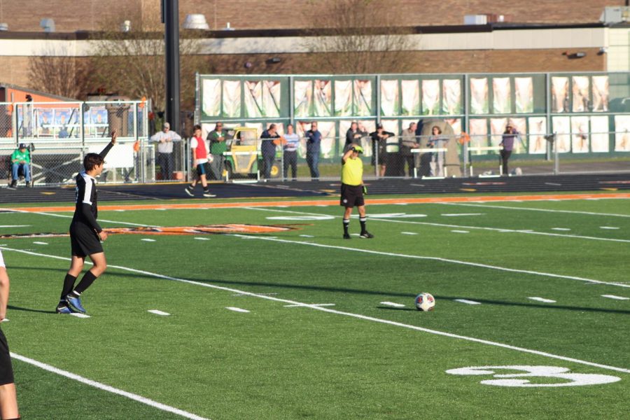 Sophomore Zac Monnett takes a free kick, waiting for the ref to blow the whistle.