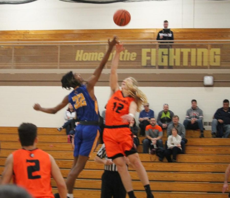 Shane Ooms tips the jump ball to start a game against Joliet Central at the WJOL tournament in November. 