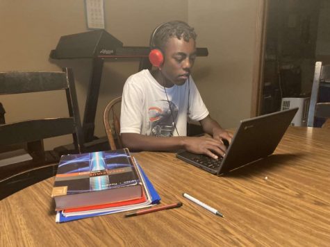 Junior Yirga Boeringa works at his designated remote learning area. Many students have found a place at home to be focused while they are in their classes. Others have just been comfortable in their beds.