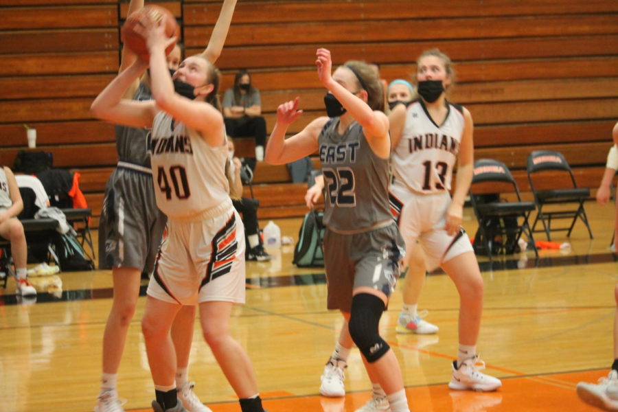 Ashley Currier puts up a shot for Minooka against Oswego East in the SPC Tournament. 