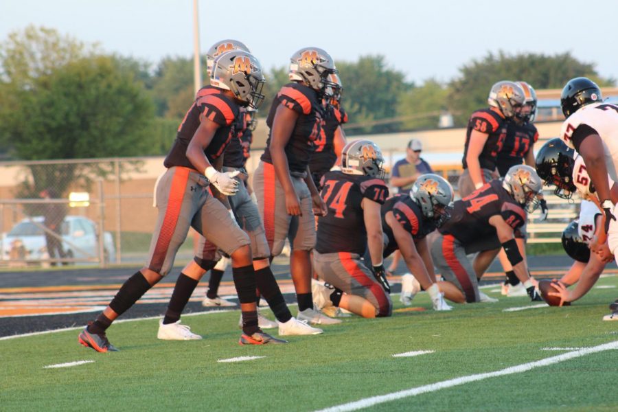 Minookas defense lines up in an early season game against Bolingbrook. 