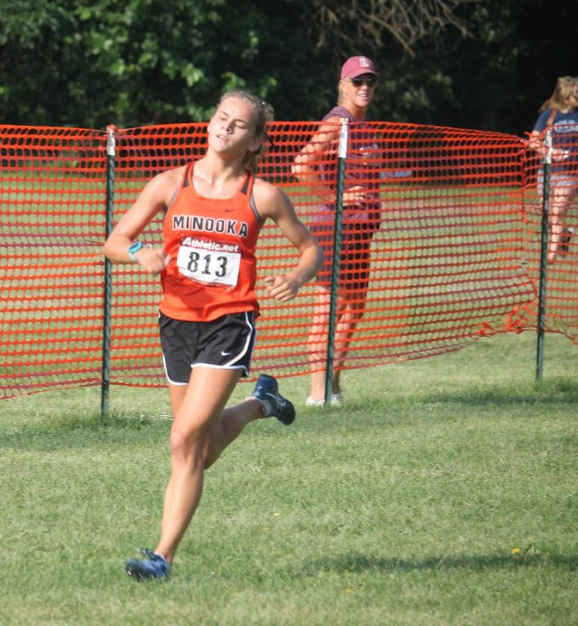 Junior Ella McCollom runs at the Normal West Invitational.  Later at the Minooka Conditioner, McCollom teamed up with Gabby Kics to win that race.
