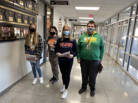 Features editor Paige Anderson, Jaidyn, editor-in-chief Gabby Roussos, and Luke deliver the first issue of the newly named Nook News to students and staff on Dec. 8