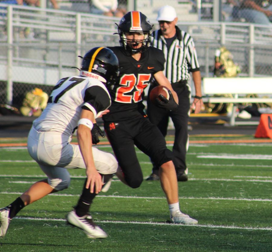 Sophomore Caden Uphoff runs the ball against Joliet West on Sept. 2.  Minooka won the game, 12-6.