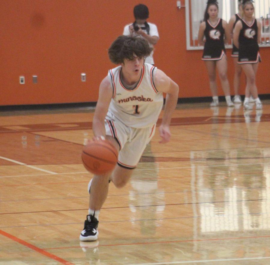 Junior Troy Hudak brings the ball up the court against Oswego on Nov. 29. Oswego won the game, 68-43.