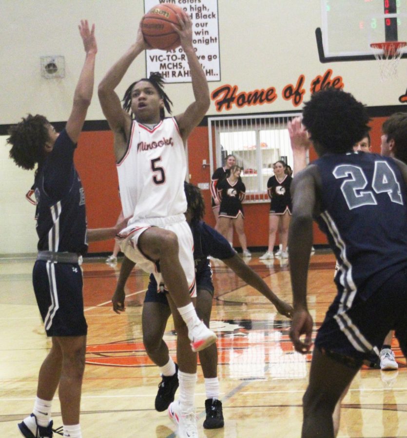 Junior Jahmai McCoy takes the ball to the basket against Oswego East on Dec. 2. 