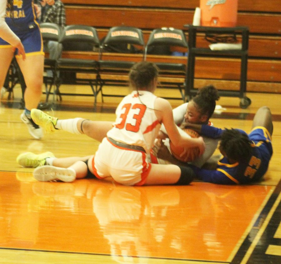 Kylie Loomis and Makenzie Brass fight for a loose ball against Joliet Central on Jan. 23.