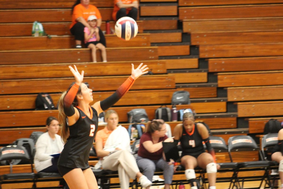 Senior+Maria+Vercelote+serves+against+Romeoville+on+Oct.+3.+