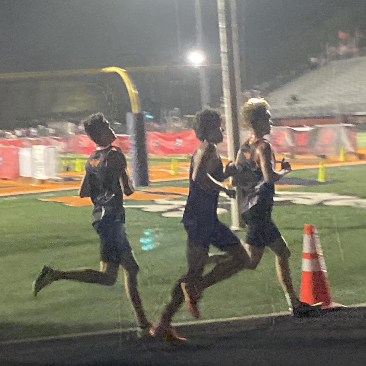 Seniors Caleb Kies and Tyler Herrera run at the Naperville North Twilight Invitational on Oct. 4. 