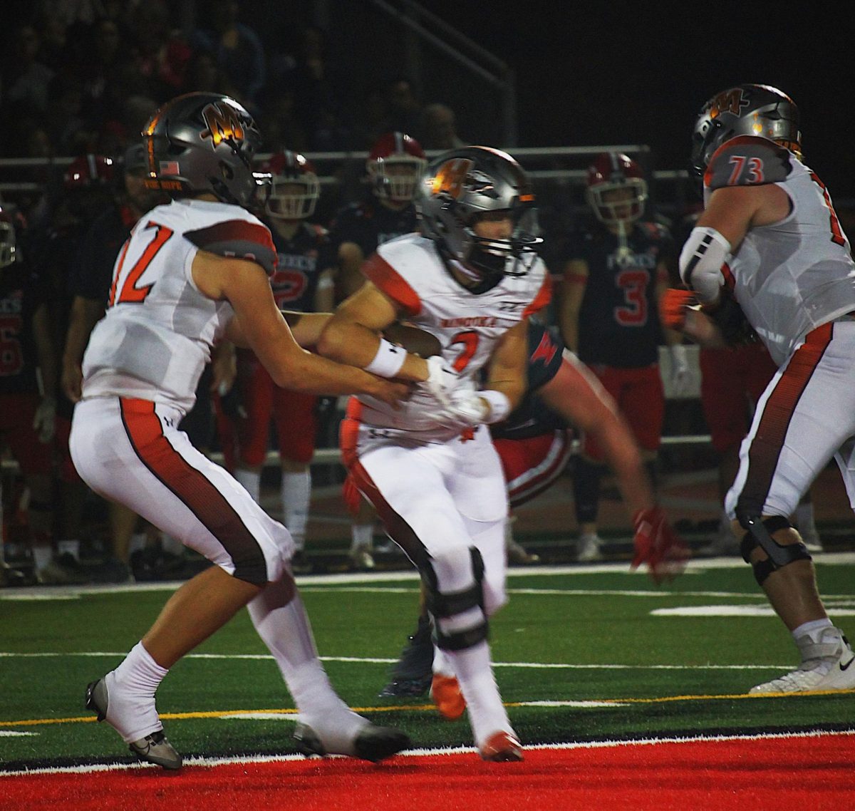 Quarterback Nate Maul hands off the ball to Joey Partridge on Sept. 29 against Yorkville.  Yorkville won the game 17-13. 