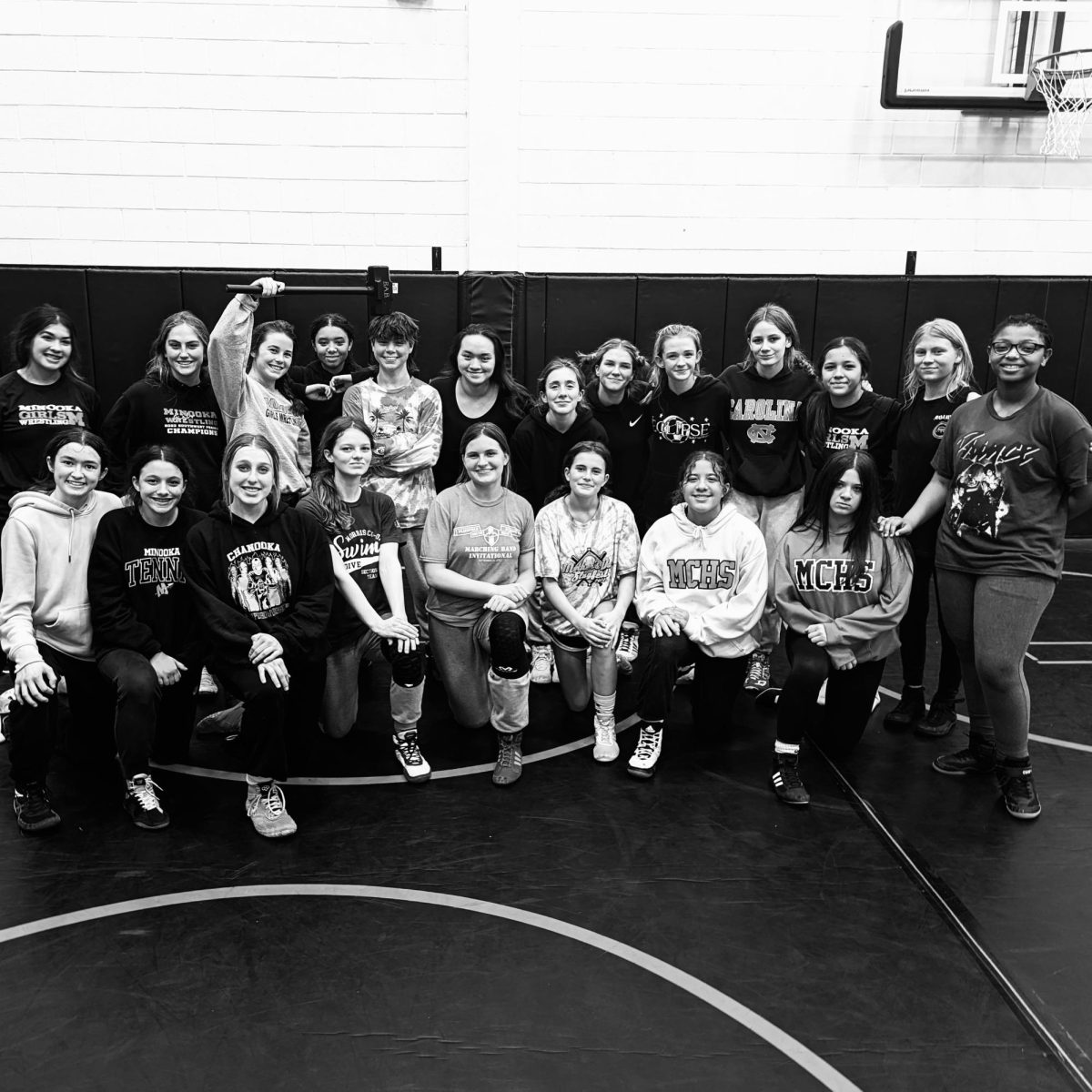 Freshmen and sophomore girls on the wrestling team take a photo after practice on Dec. 7.