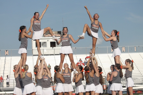 The JV cheerleading team performs at the home football game against Rock Island on Aug. 25.