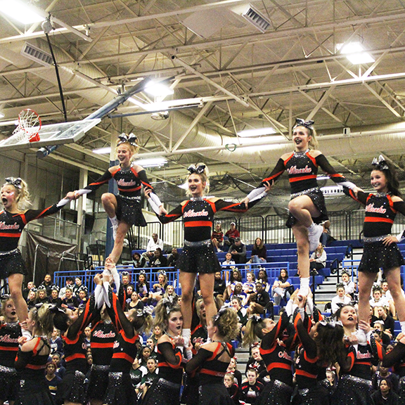 Varsity cheerleaders perform at competition. 