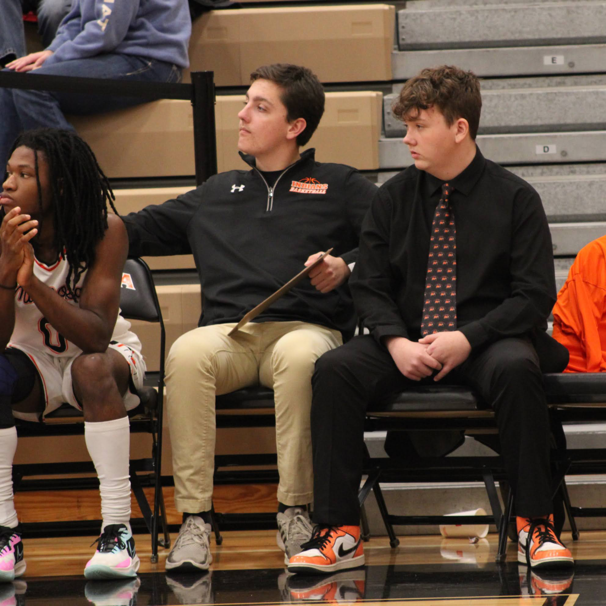 Juniors Camden Swanson and Brendyn Jacobs help out during the Dec. 15 varsity boys basketball team against Romeoville.  They are the teams managers. 