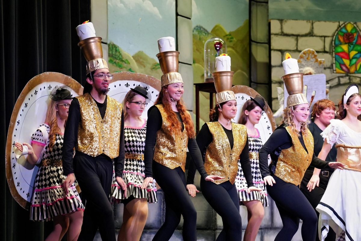 Cast members sing and dance during Be Our Guest in the school musical Beauty and the Beast. 