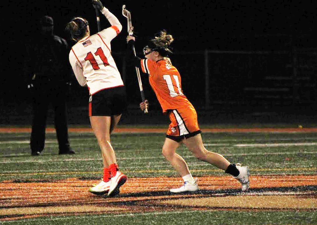 Senior midfield Gaby Quinones catches the ball to move it upfield against Washington on April 5. Minooka won 18-7.