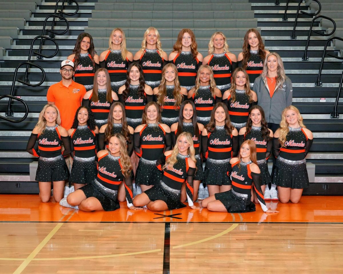 The head coach of the varsity cheer team is Ashley Cook. 