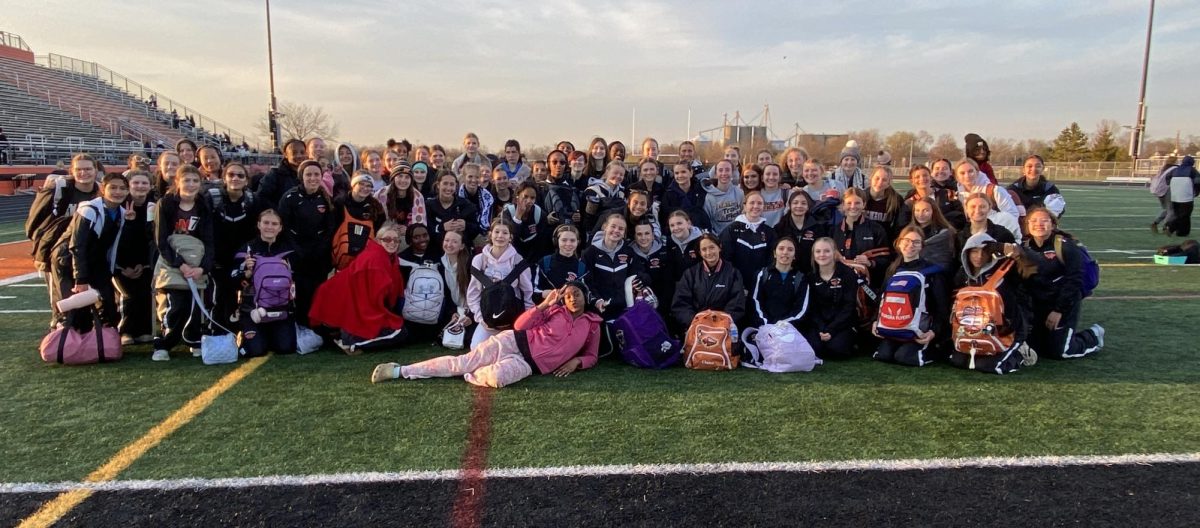 The girls track and field team takes a photo after winning a triangular meet against Oswego East and Joliet West. The head coach of the team is Kevin Gummerson. 